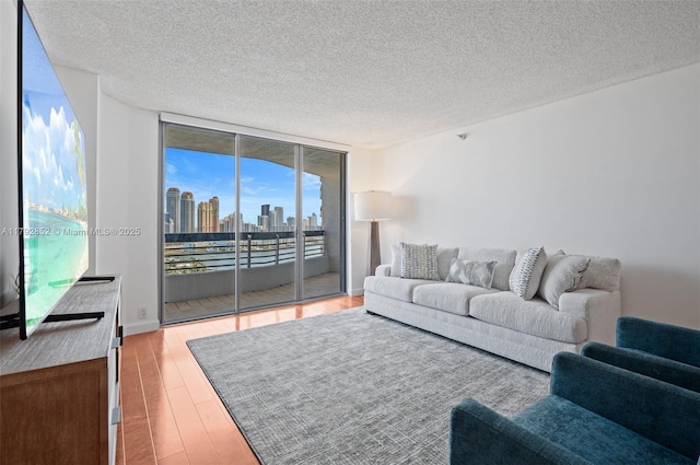 19101 NE 36th Ct Unit 2509, Aventura, FL 33180 - living area with a wall of windows, a textured ceiling, and wood finished floors