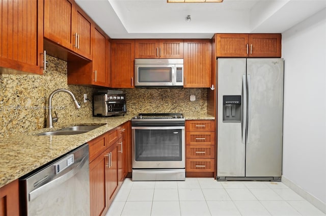 19101 NE 36th Ct Unit 2509, Aventura, FL 33180 - kitchen featuring light stone countertops, appliances with stainless steel finishes, a sink, and tasteful backsplash
