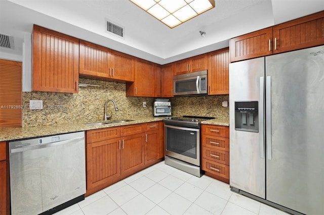 19101 NE 36th Ct Unit 2509, Aventura, FL 33180 - kitchen with decorative backsplash, visible vents, appliances with stainless steel finishes, light stone countertops, and a sink