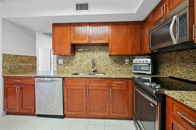 19101 NE 36th Ct Unit 2509, Aventura, FL 33180 - kitchen featuring light stone countertops, a sink, stainless steel appliances, tasteful backsplash, and visible vents
