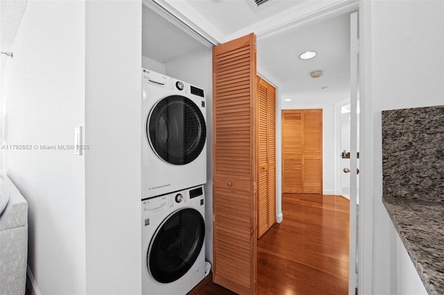 19101 NE 36th Ct Unit 2509, Aventura, FL 33180 - laundry room featuring stacked washer and clothes dryer, recessed lighting, wood finished floors, and laundry area