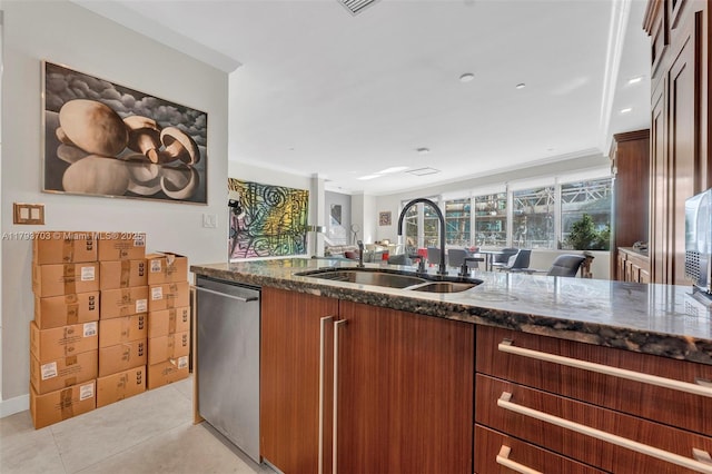 kitchen featuring a sink, dark stone counters, open floor plan, and dishwasher