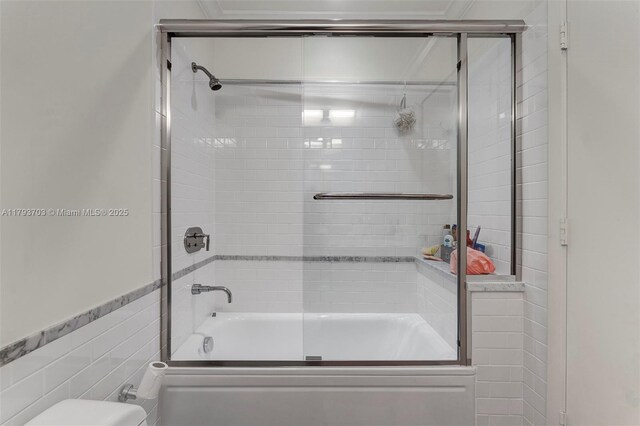 6101 Aqua Ave Unit 103, Miami Beach, FL 33141 - bathroom featuring shower / bath combination with glass door and tile walls