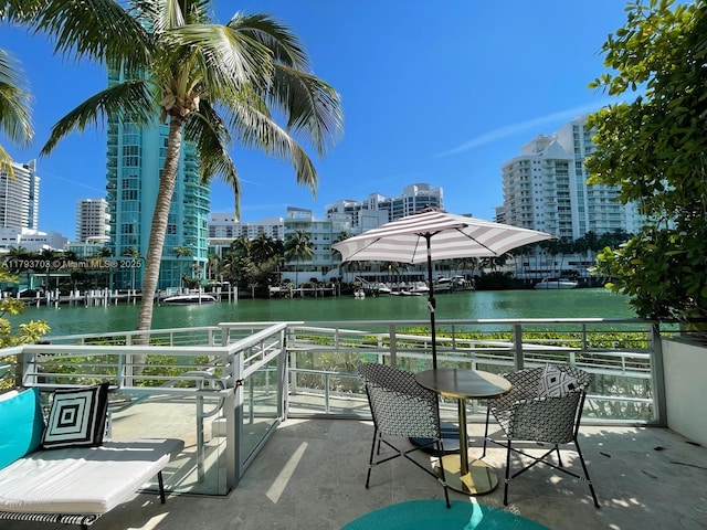 view of patio featuring a water view and a city view