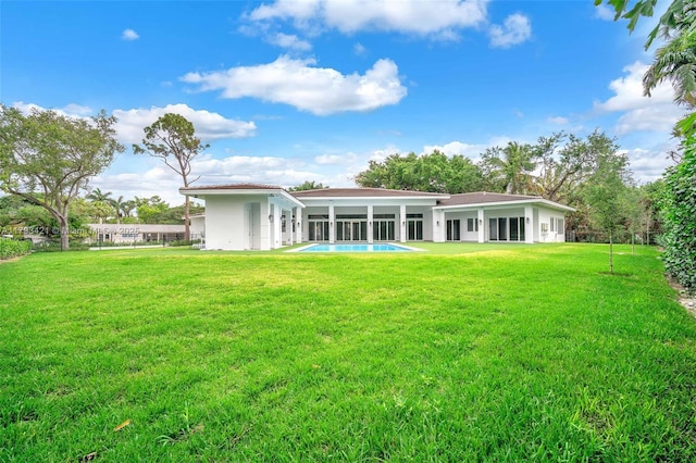 7900 SW 70th St, Miami, FL 33143 - back of house featuring a yard, stucco siding, and an outdoor pool