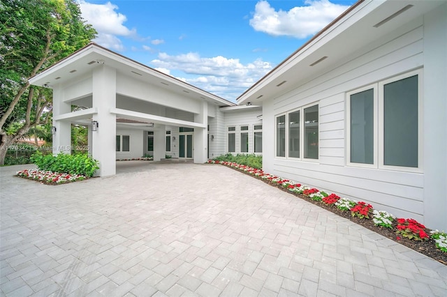 7900 SW 70th St, Miami, FL 33143 - view of patio featuring decorative driveway and a carport