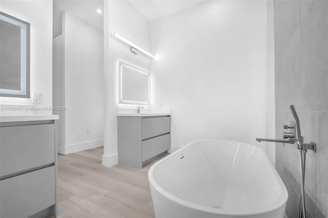 7900 SW 70th St, Miami, FL 33143 - full bathroom featuring vanity, wood finished floors, and a freestanding bath
