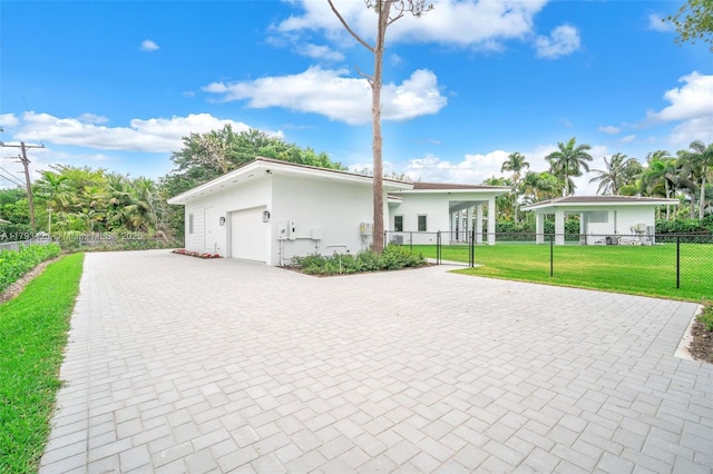 7900 SW 70th St, Miami, FL 33143 - view of front of house with decorative driveway, a garage, and stucco siding