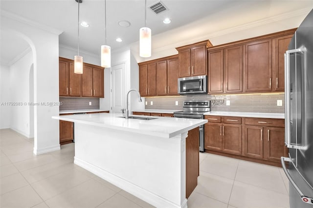 kitchen featuring brown cabinetry, visible vents, appliances with stainless steel finishes, a sink, and ornamental molding