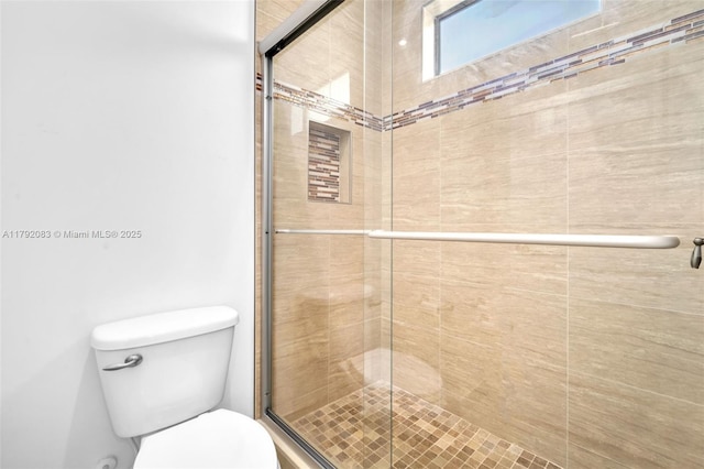 full bath featuring toilet and a stall shower