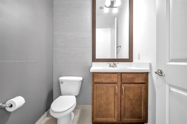 half bathroom featuring vanity and toilet