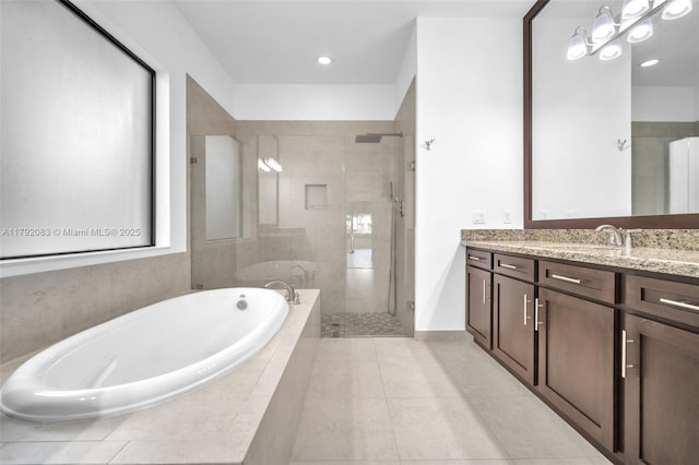 bathroom with a bath, a stall shower, vanity, tile patterned floors, and recessed lighting