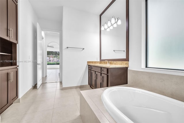 bathroom with vanity, tile patterned floors, and a bath