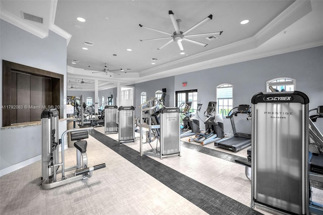 gym featuring ceiling fan, visible vents, crown molding, a tray ceiling, and recessed lighting