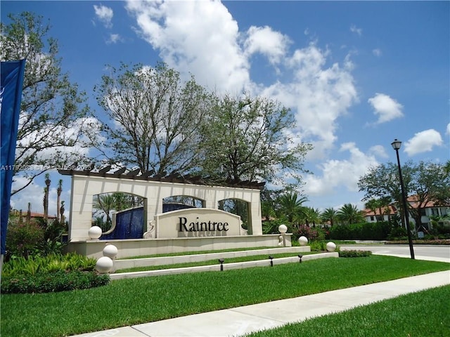 community sign featuring a lawn