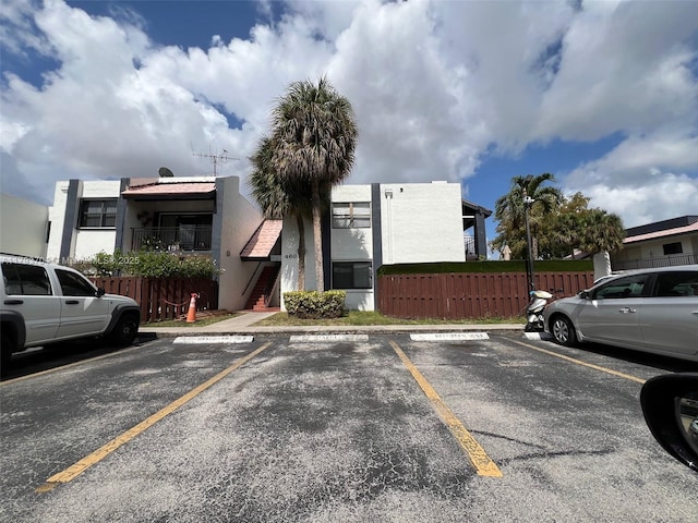 460 W Park Dr Unit 103, Miami, FL 33172 - uncovered parking lot with fence and stairway