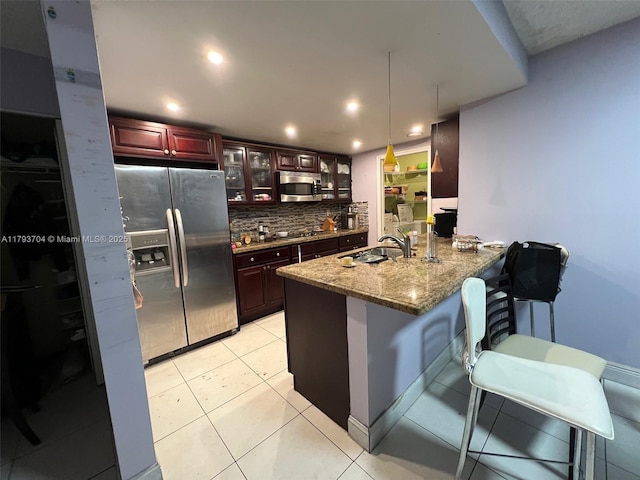 460 W Park Dr Unit 103, Miami, FL 33172 - kitchen with backsplash, appliances with stainless steel finishes, a sink, a peninsula, and glass insert cabinets