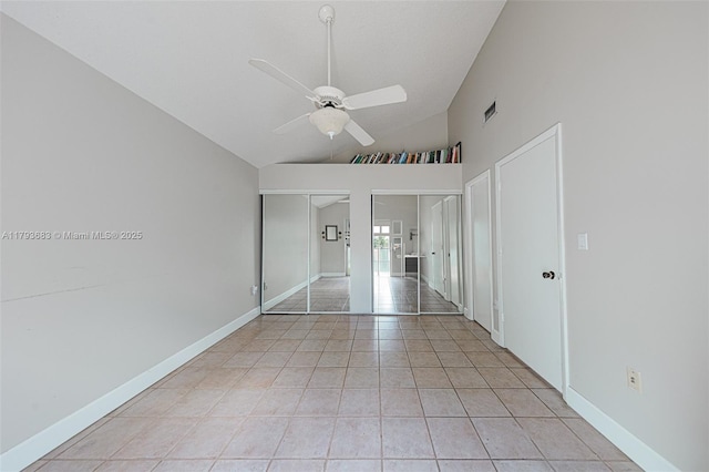 unfurnished bedroom featuring high vaulted ceiling, two closets, a ceiling fan, light tile patterned floors, and visible vents