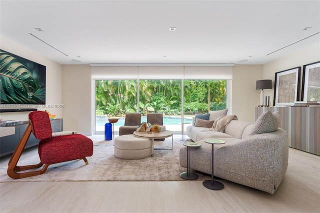 living area with expansive windows and wood finished floors