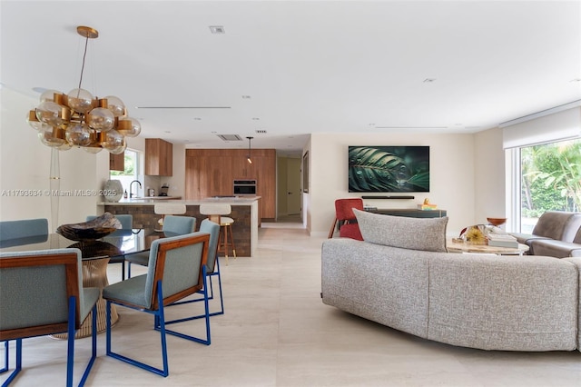 living room featuring a chandelier and a healthy amount of sunlight