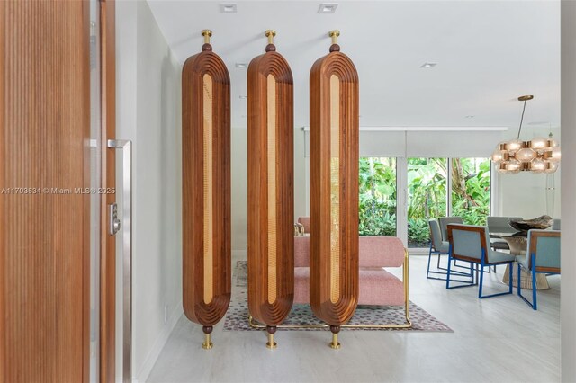 1075 NE 99th St, Miami Shores, FL 33138 - hall with expansive windows and a chandelier