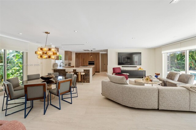 1075 NE 99th St, Miami Shores, FL 33138 - living room with plenty of natural light, recessed lighting, and a chandelier