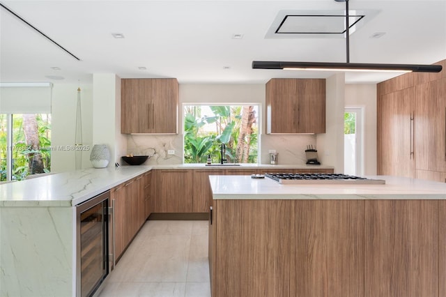 kitchen featuring wine cooler, modern cabinets, and gas stovetop