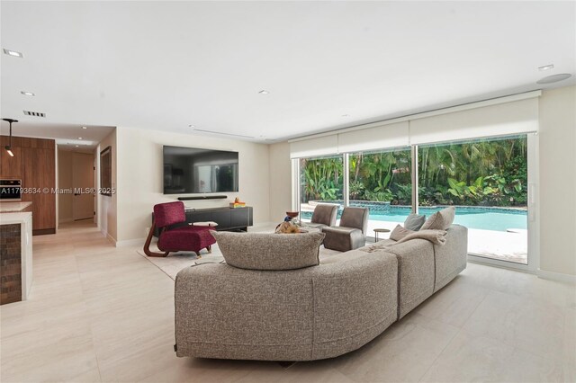 1075 NE 99th St, Miami Shores, FL 33138 - living room featuring healthy amount of natural light, recessed lighting, and light tile patterned floors