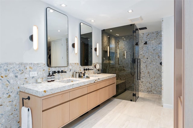 full bath with a sink, tile patterned flooring, double vanity, tasteful backsplash, and a stall shower