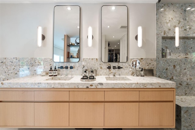 bathroom featuring vanity and backsplash