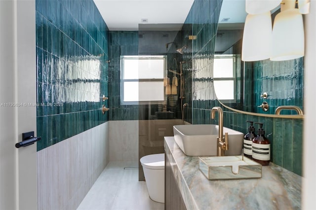 full bathroom featuring visible vents, tile walls, walk in shower, vanity, and toilet