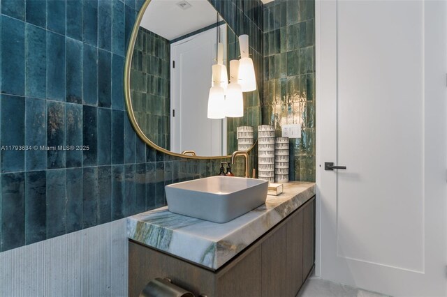 1075 NE 99th St, Miami Shores, FL 33138 - bathroom with vanity, tasteful backsplash, and tile walls