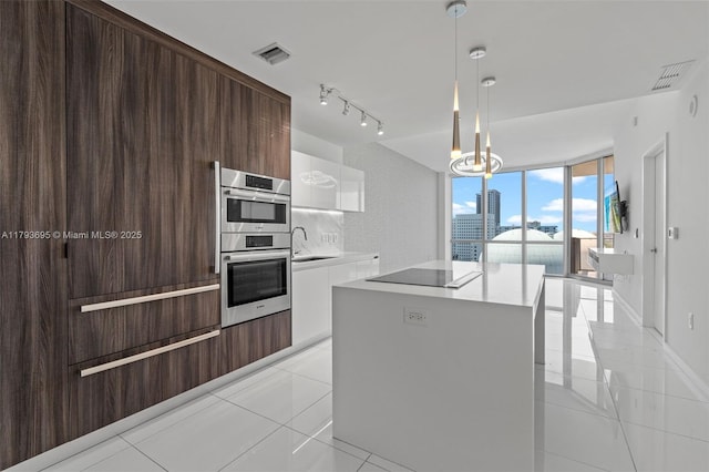 851 NE 1st Ave Unit 1506, Miami, FL 33132 - kitchen featuring visible vents, modern cabinets, a sink, and double oven