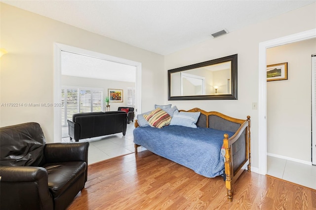 10761 SW 113th Pl Unit 102D, Miami, FL 33176 - bedroom featuring baseboards, light wood-style flooring, and visible vents
