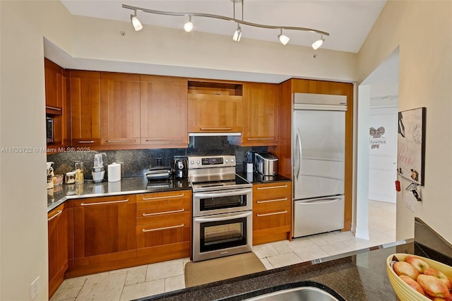333 Las Olas Way Unit 2401, Fort Lauderdale, FL 33301 - kitchen featuring brown cabinets, open shelves, appliances with stainless steel finishes, dark stone counters, and decorative backsplash