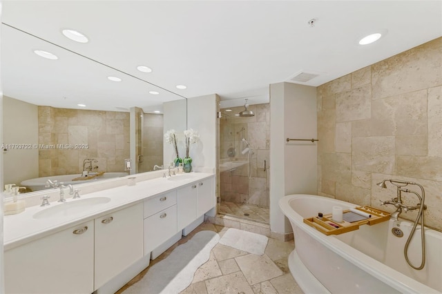 333 Las Olas Way Unit 2401, Fort Lauderdale, FL 33301 - full bathroom featuring double vanity, a freestanding tub, a sink, and a stall shower
