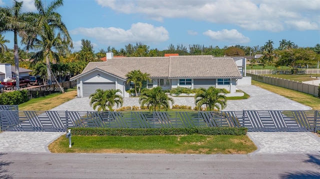 3401 SW 141st Ave, Miramar, FL 33027 - ranch-style house featuring a fenced front yard, a tile roof, decorative driveway, and a chimney