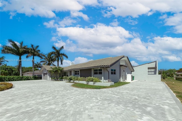 3401 SW 141st Ave, Miramar, FL 33027 - view of front of property with decorative driveway, a tiled roof, an attached garage, and stucco siding