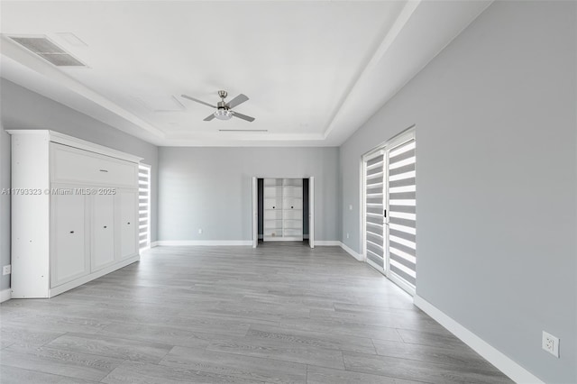 3401 SW 141st Ave, Miramar, FL 33027 - unfurnished bedroom featuring a tray ceiling, light wood-style floors, baseboards, and ceiling fan