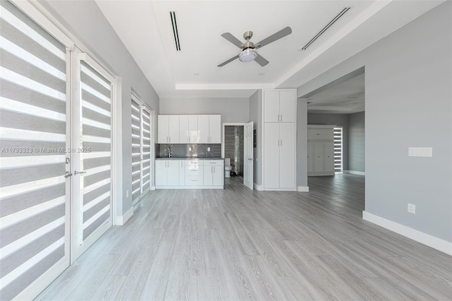 3401 SW 141st Ave, Miramar, FL 33027 - unfurnished living room with a raised ceiling, a ceiling fan, baseboards, and light wood finished floors