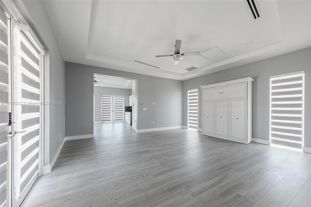 3401 SW 141st Ave, Miramar, FL 33027 - unfurnished bedroom with a tray ceiling, light wood finished floors, and baseboards