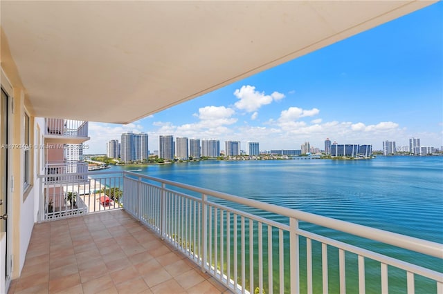 balcony featuring a view of city and a water view