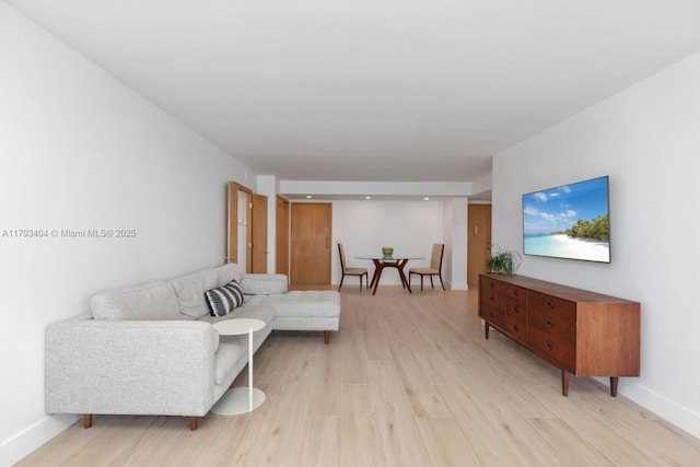 living room with light wood-style floors and baseboards