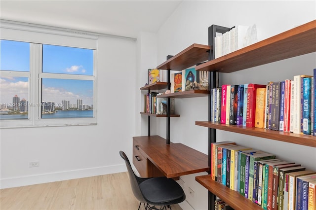 office space with baseboards and wood finished floors