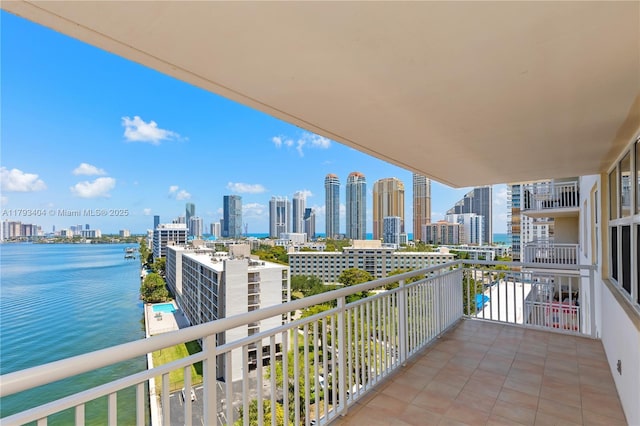 balcony with a water view and a city view