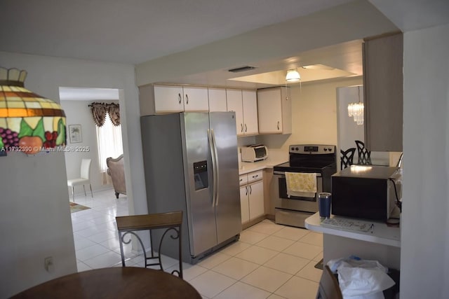 4701 NW 43rd Ave, Tamarac, FL 33319 - kitchen featuring light tile patterned floors, white cabinets, stainless steel appliances, and visible vents