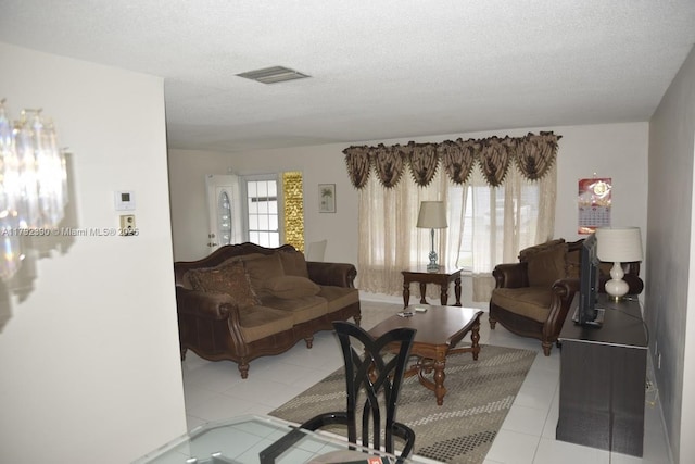 4701 NW 43rd Ave, Tamarac, FL 33319 - living area featuring tile patterned flooring, a textured ceiling, and visible vents