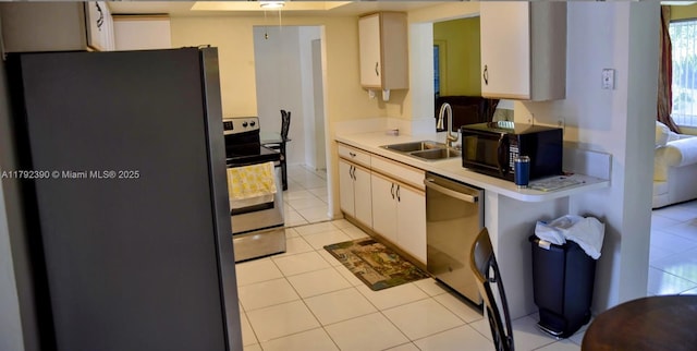 4701 NW 43rd Ave, Tamarac, FL 33319 - kitchen featuring light countertops, a sink, light tile patterned floors, and stainless steel appliances