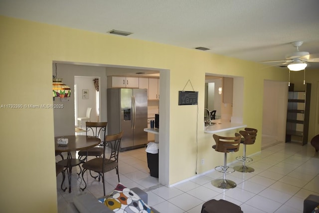 4701 NW 43rd Ave, Tamarac, FL 33319 - interior space featuring light countertops, stainless steel refrigerator with ice dispenser, visible vents, and a kitchen bar