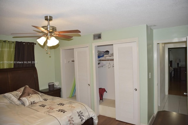 4701 NW 43rd Ave, Tamarac, FL 33319 - bedroom featuring visible vents, a ceiling fan, multiple closets, and wood finished floors